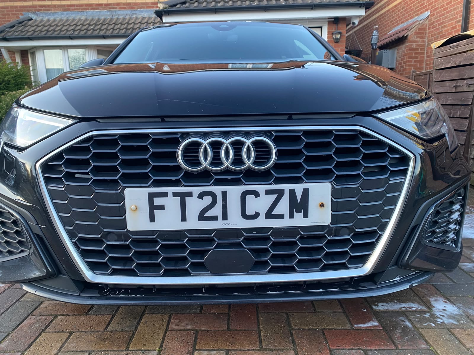 Close-up of a spotless Audi front grille and bonnet