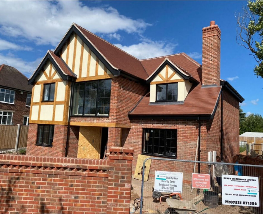 Completed new build detached house with red brick elevations and boundary wall built by Derby Brickwork Ltd