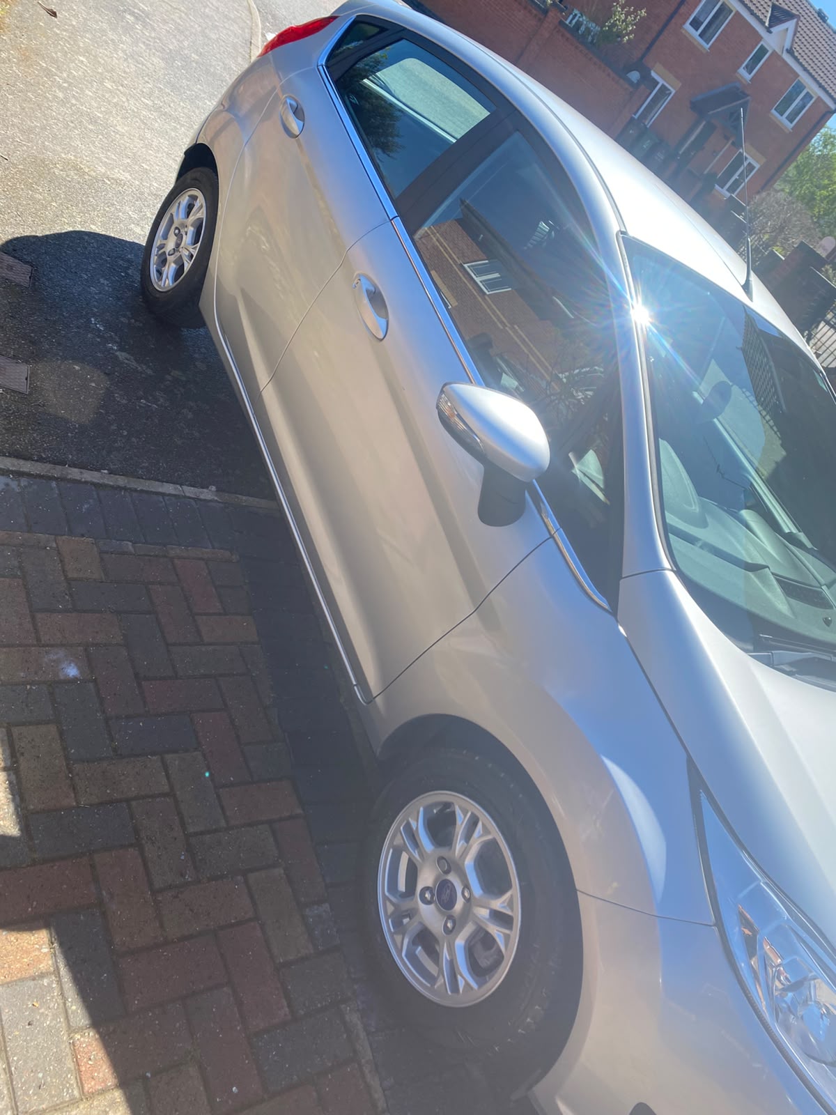 Silver Ford gleaming in the sun after a full wash