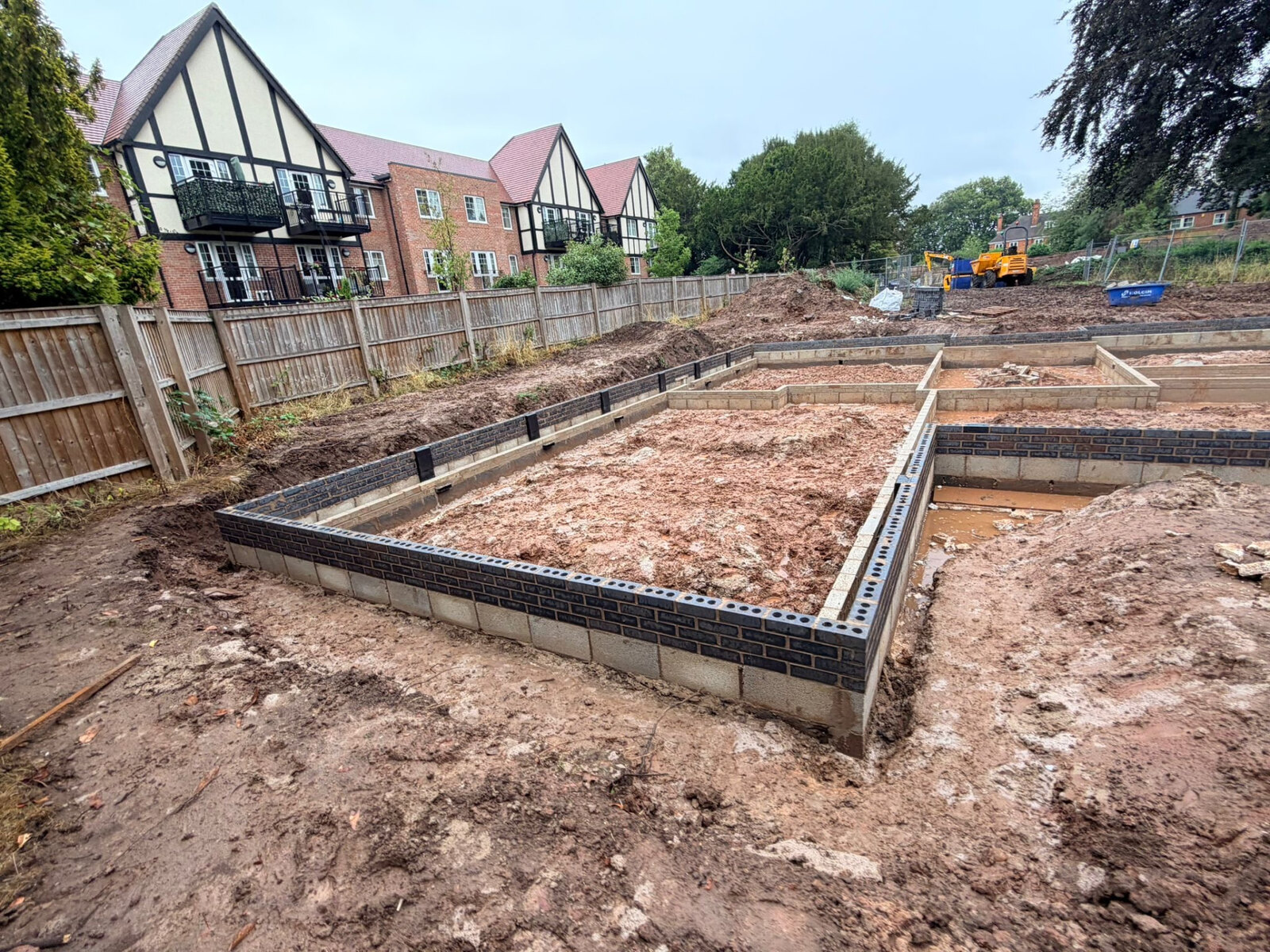 Foundation brickwork in blue engineering brick set out for new build plots