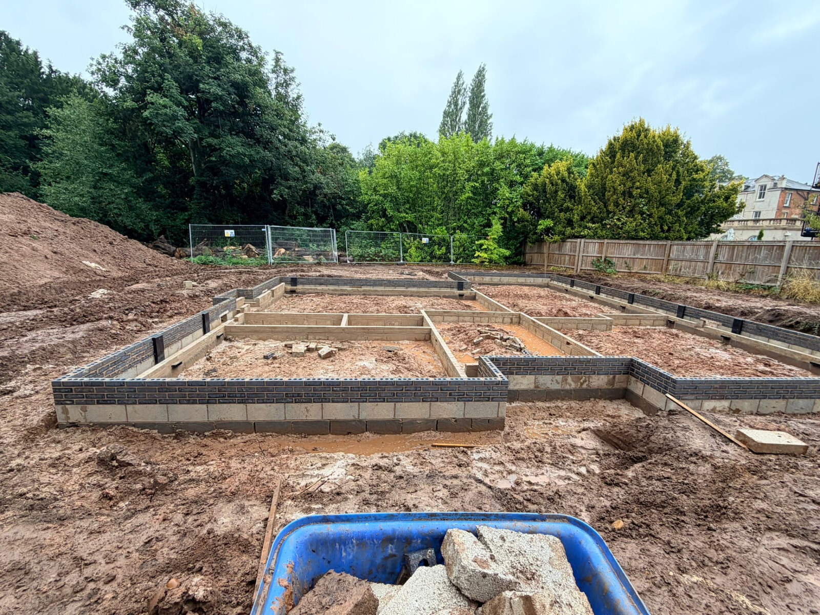 New build substructure with blockwork and blue engineering brick courses across a Derby plot