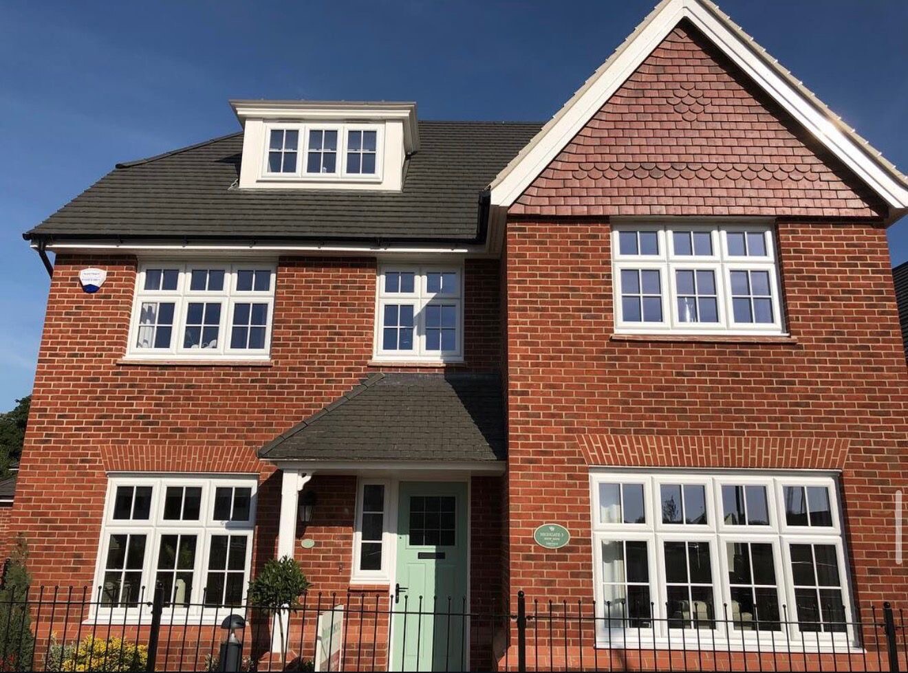 Completed new build detached red brick house with tile hung feature gable and dormer window