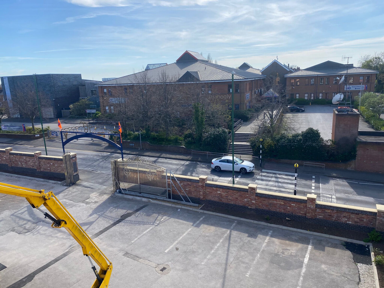 Aerial view of a new brick boundary wall with piers, coping and sliding gate