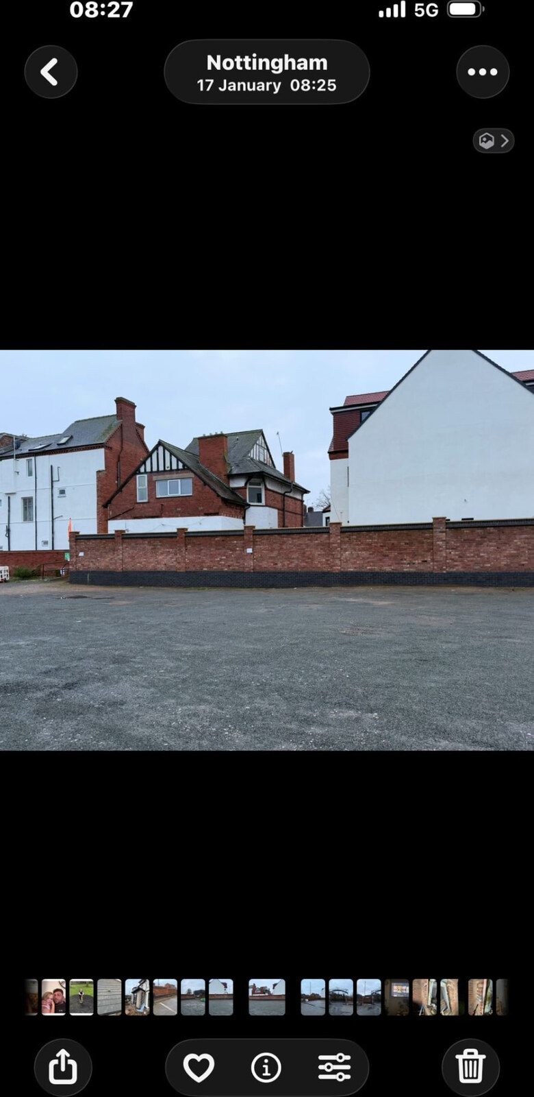 Red brick car park boundary wall with blue brick plinth and piers in Nottingham