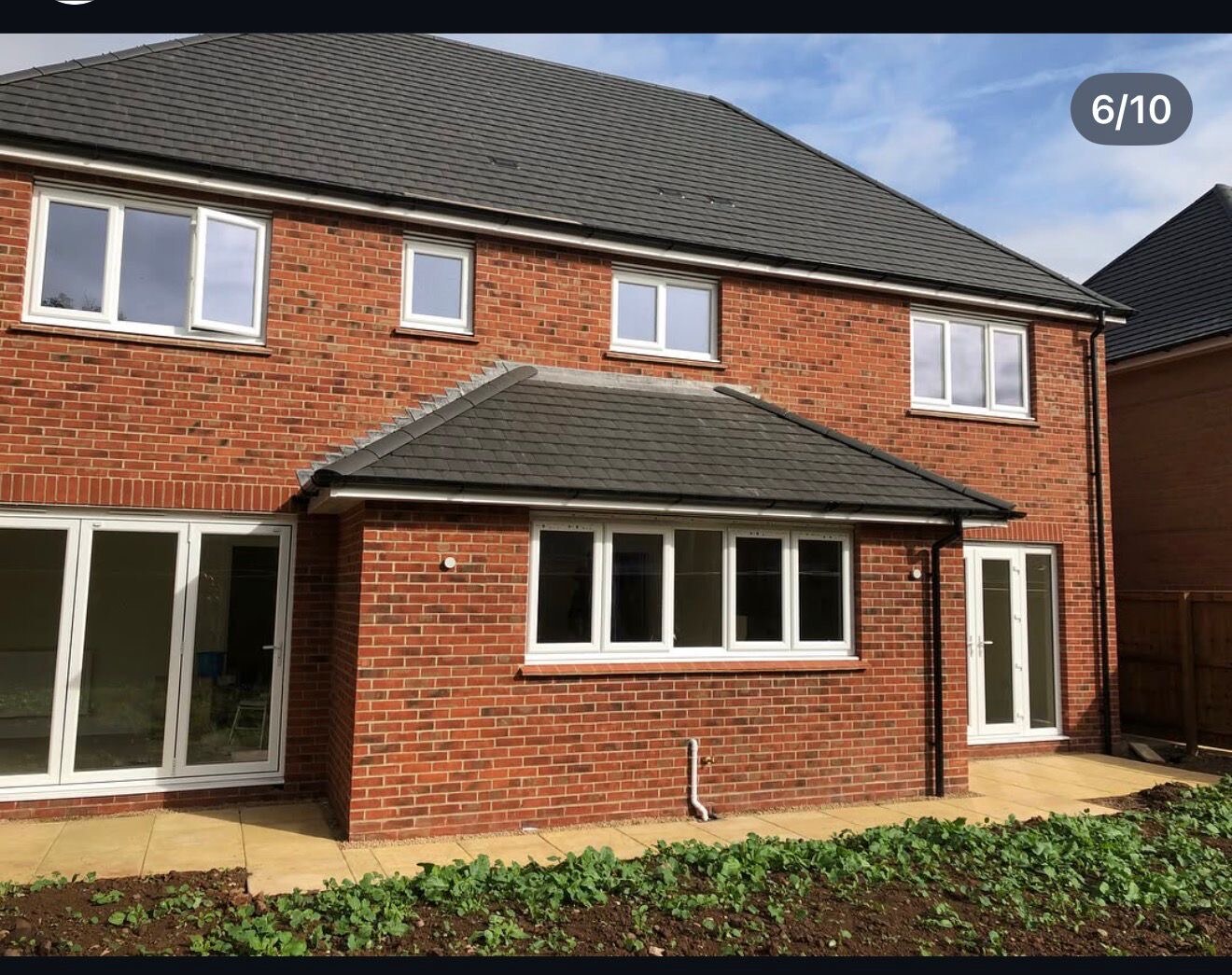 Rear elevations of completed new build semi detached homes in red brick