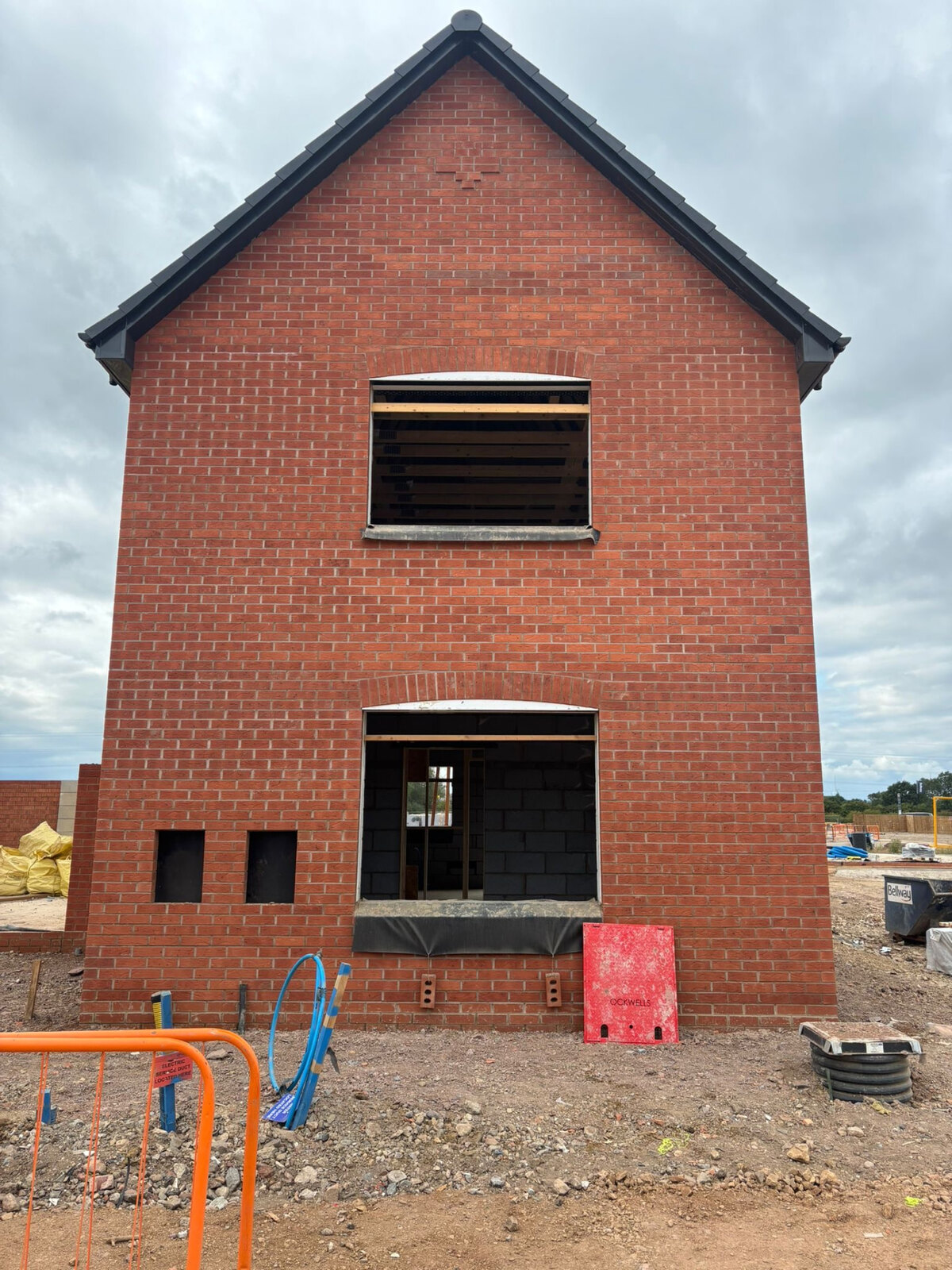 New build house gable in red brickwork with soldier course arches over window openings on a Bellway site