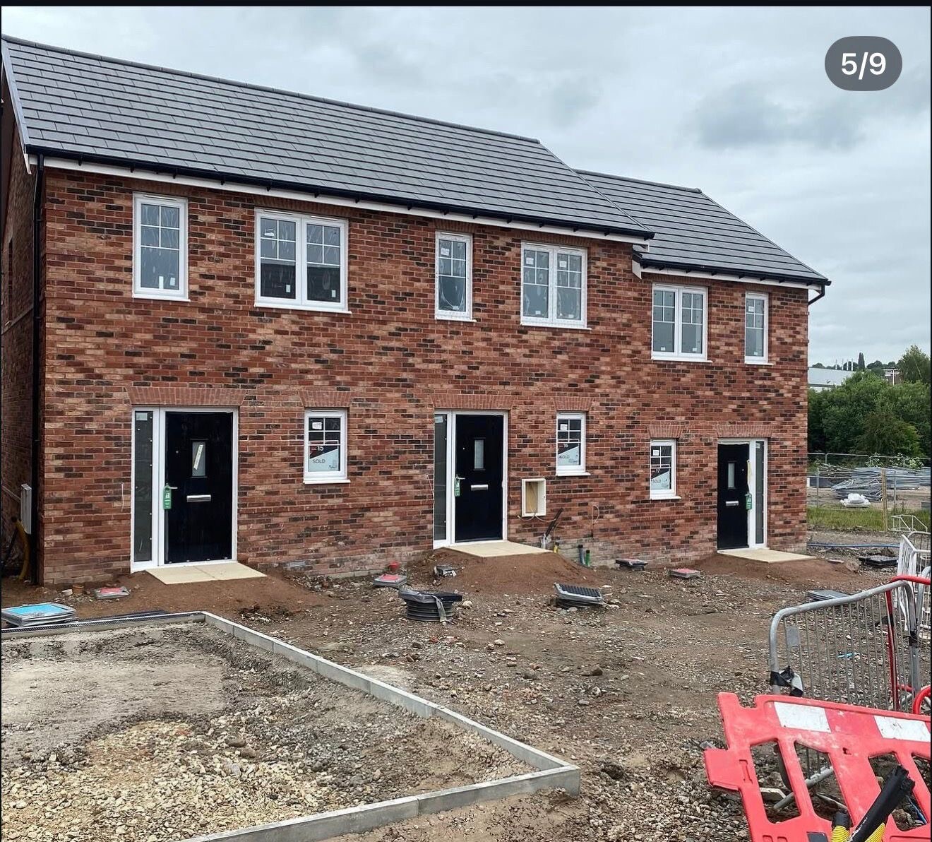 Terrace of new build homes completed in character red facing brickwork