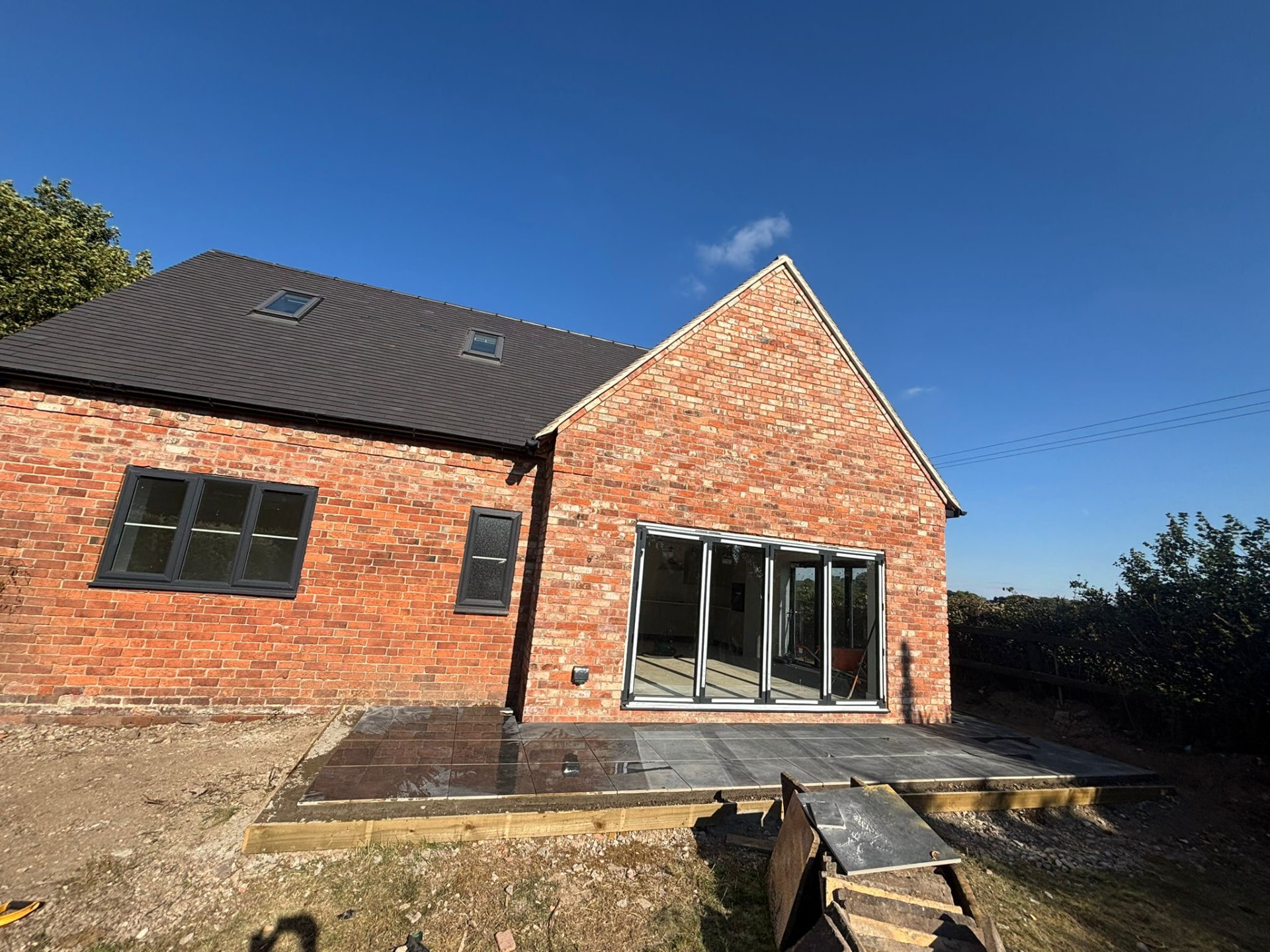 Restored reclaimed brick barn conversion with gable end and bifold doors