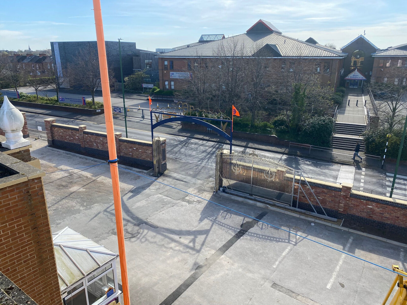 Brick frontage wall with piers, stone coping and gated entrance in Nottingham