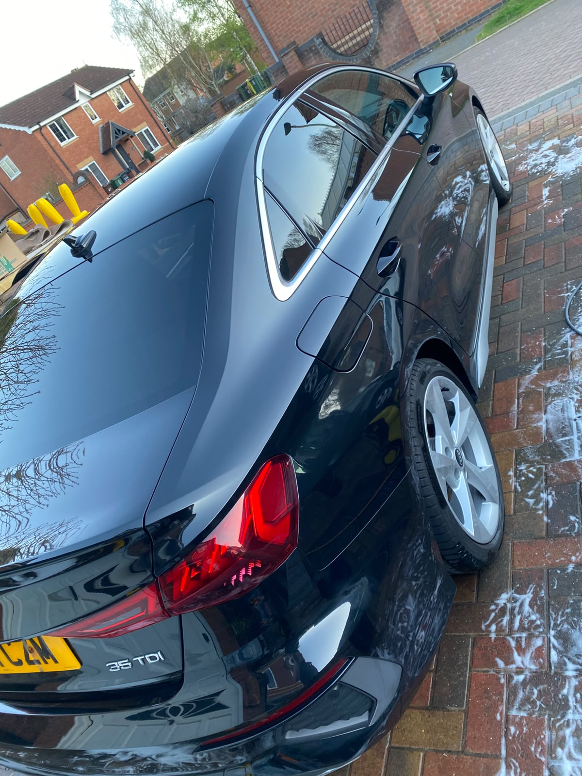 Black Audi rear three-quarter with a deep gloss finish