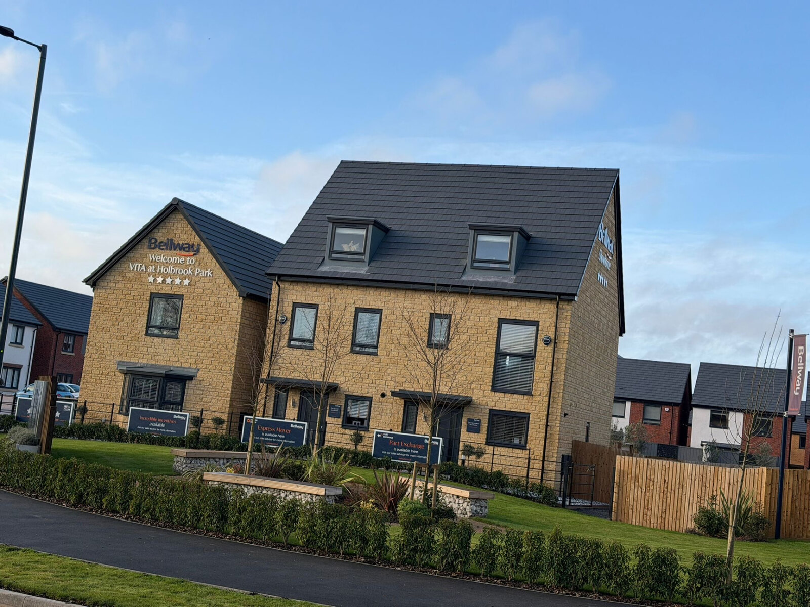 Completed three storey new build homes in reconstituted stone on a Bellway development