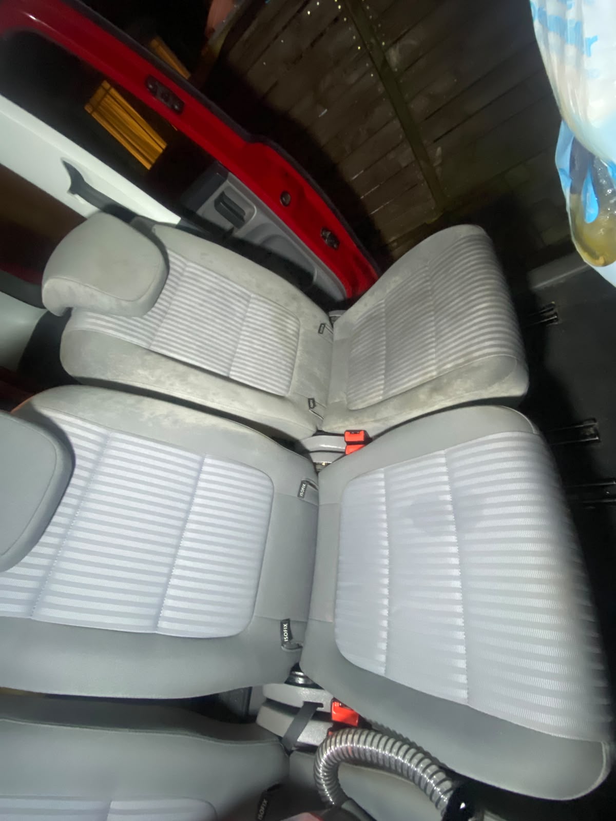Wet extraction shampoo being worked into fabric seats