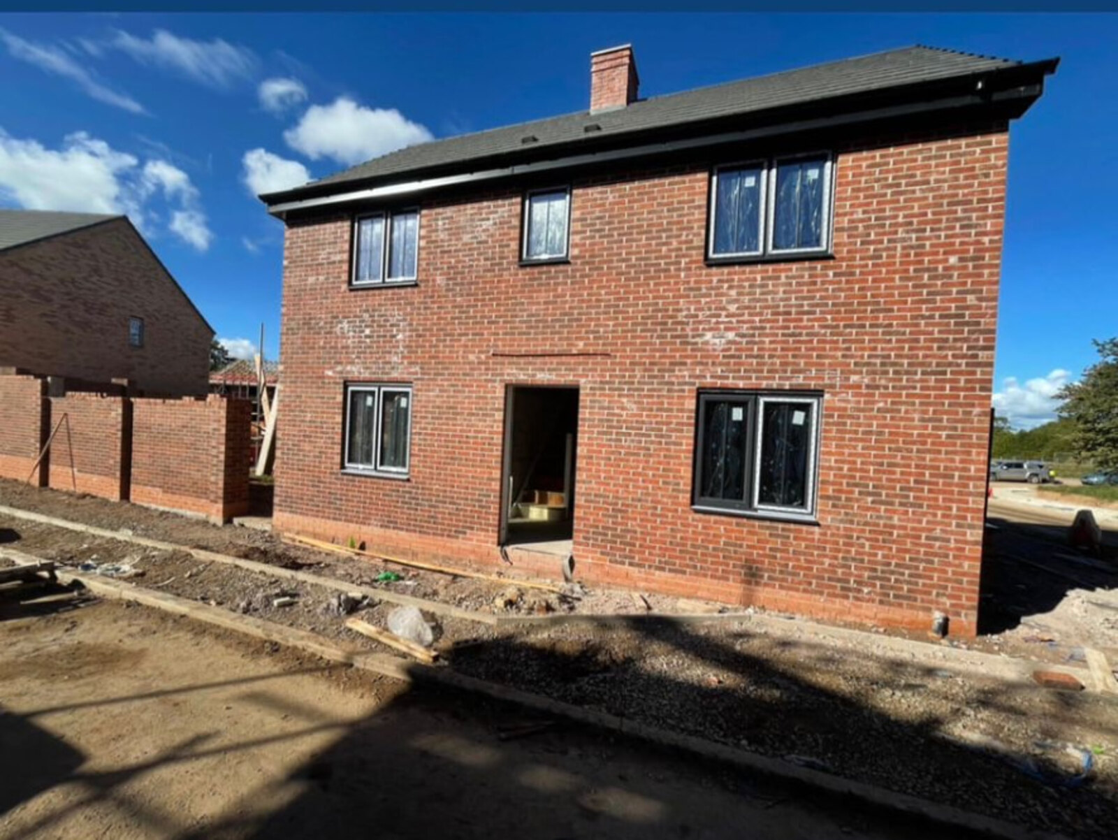 New build detached house in red brickwork with boundary walls at Quarndon, Derby