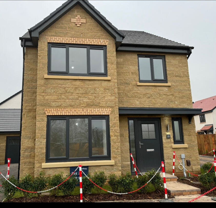 Completed new build detached house with natural stone elevations and brick detailing in Derbyshire