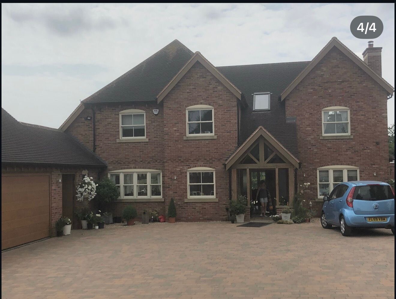 Large detached brick home with oak framed porch and multi brick elevations