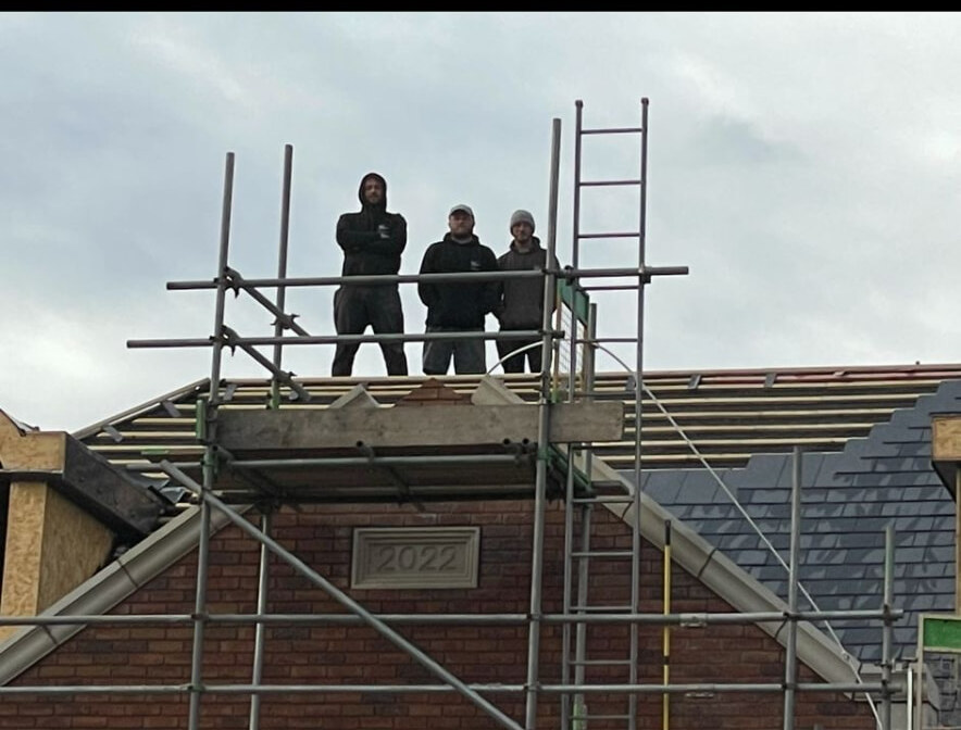 Bricklaying team on scaffold at a Nottingham gable with 2022 datestone