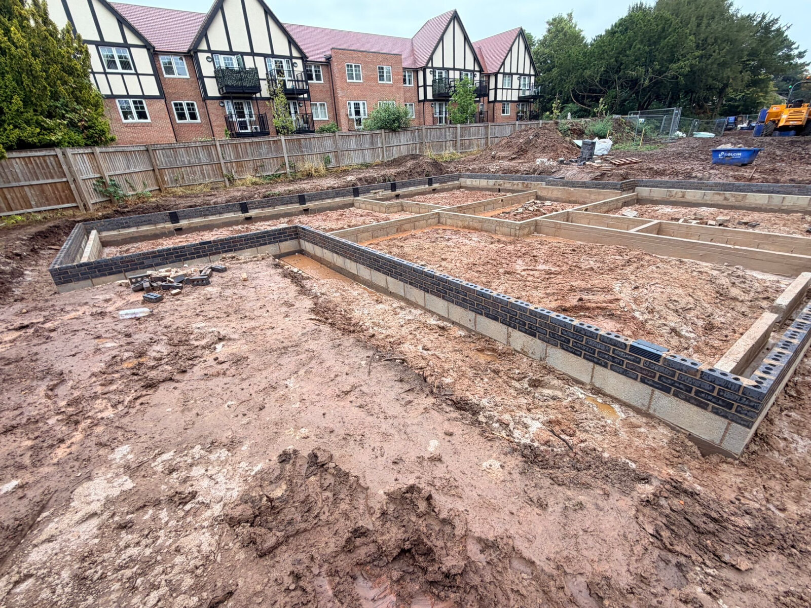 New build plot with blockwork and blue brick substructure walls built to damp proof course level