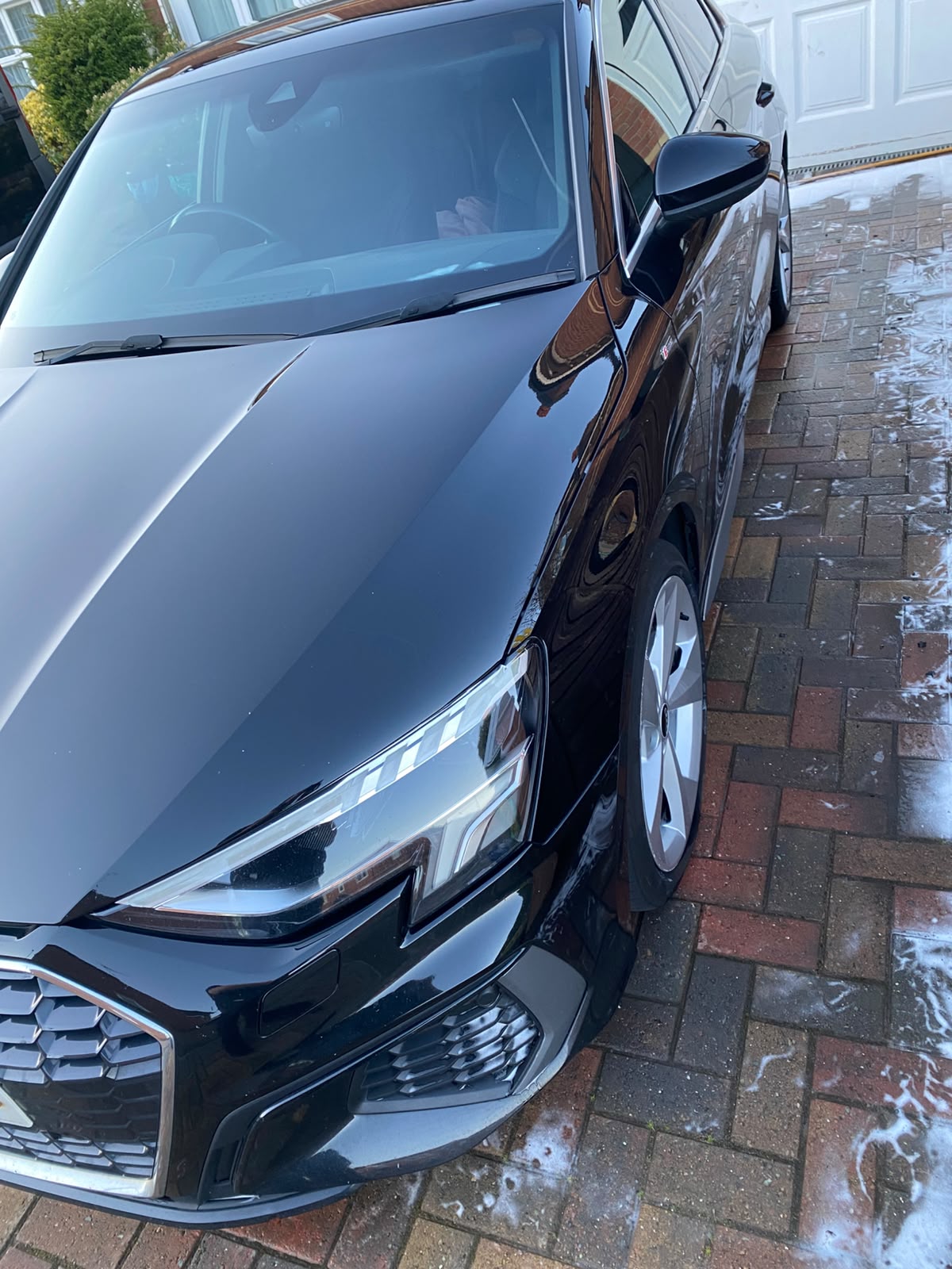 Black Audi front three-quarter with a deep gloss finish