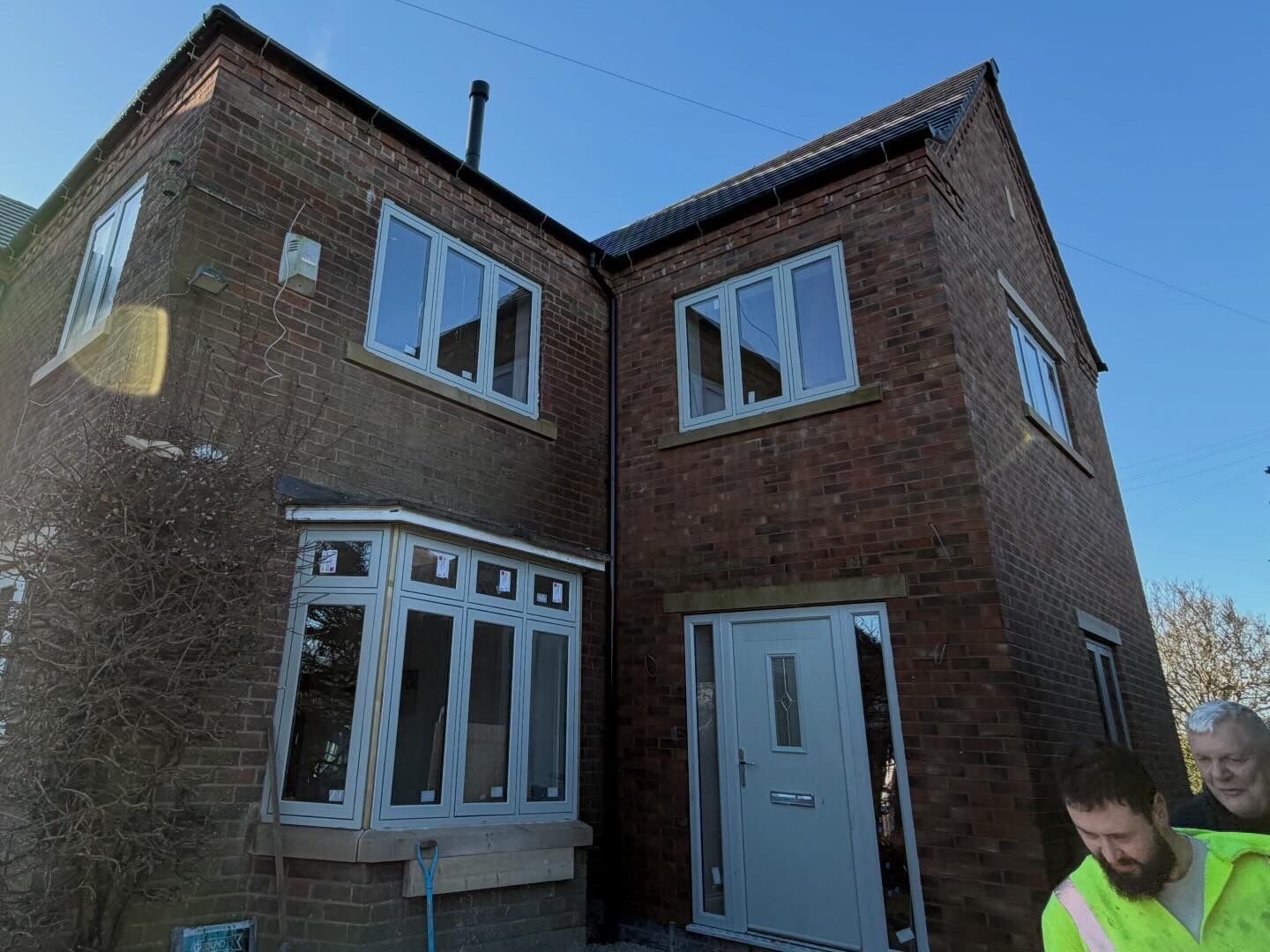 Two storey red brick extension with new bay window and stone cills