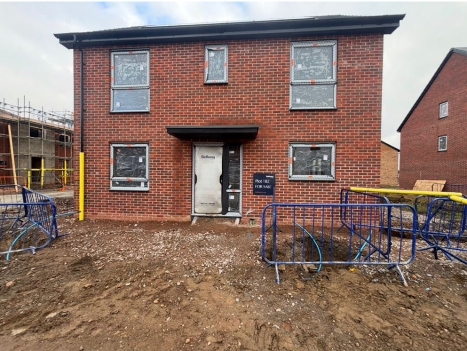 New build detached house frontage in red brickwork on a Bellway development at Thulston, Derby