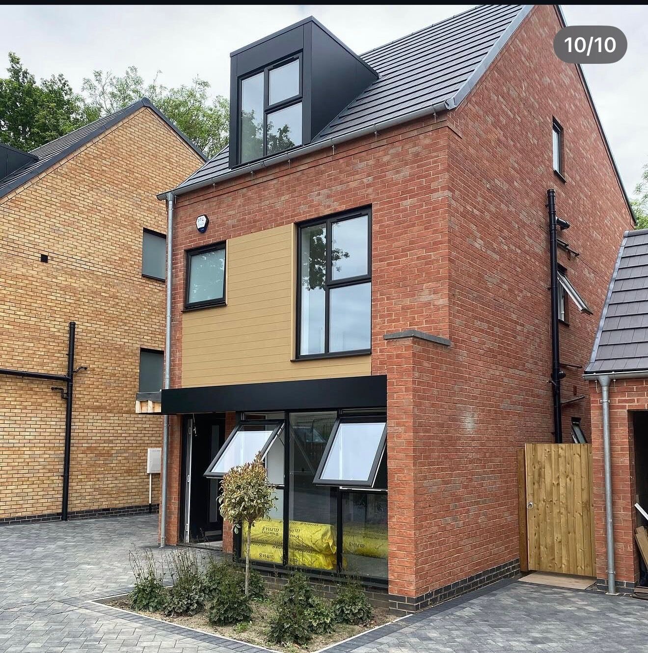 Completed three storey new build townhouse in red brick with cladding panel
