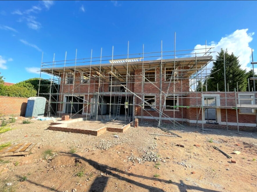 New build brick shell under scaffolding on a Bramcote plot in Nottingham