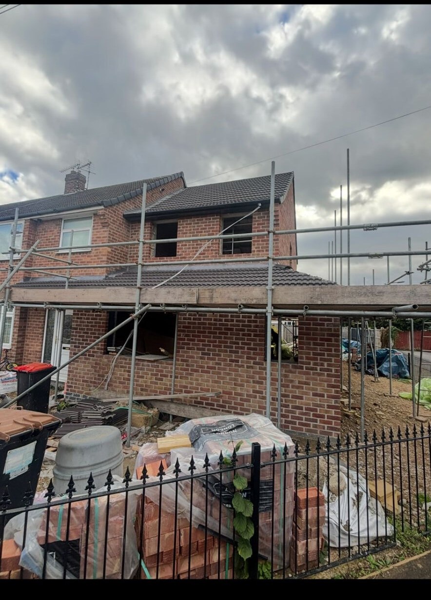 Two storey brick extension under scaffold to a semi detached house in Toton