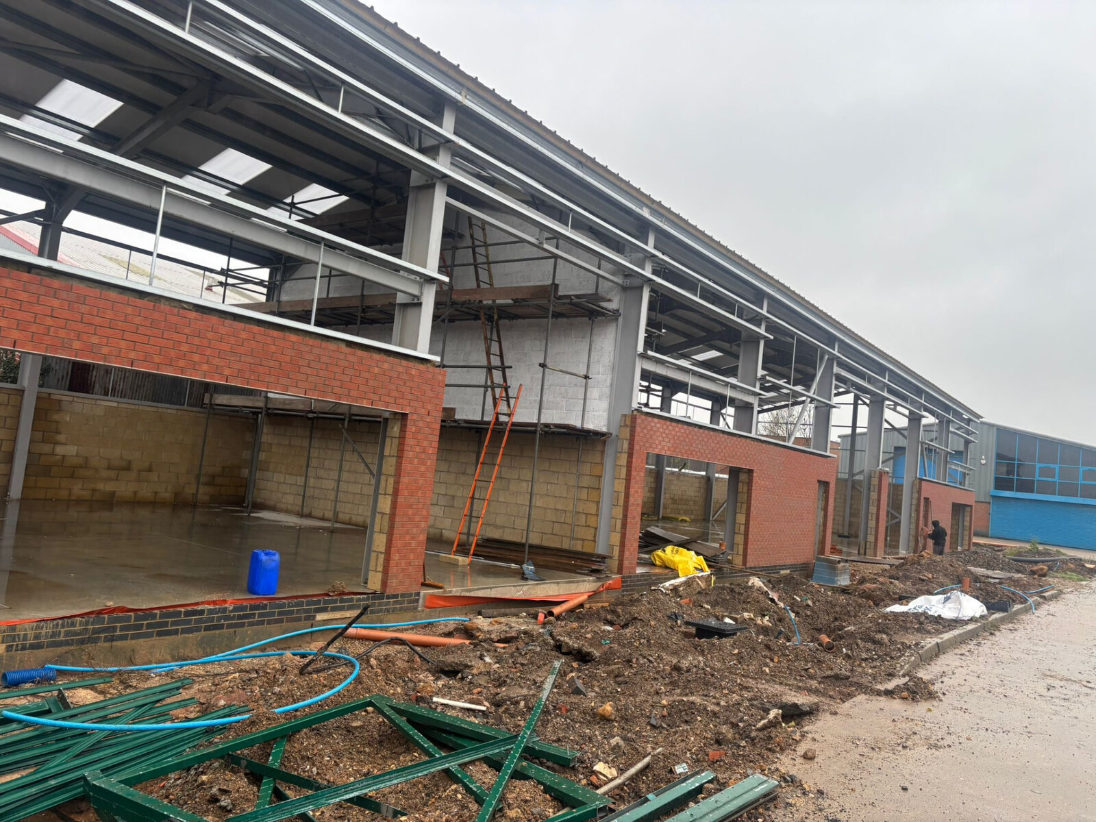 Commercial unit under construction with brick piers, blockwork infill panels and steel frame