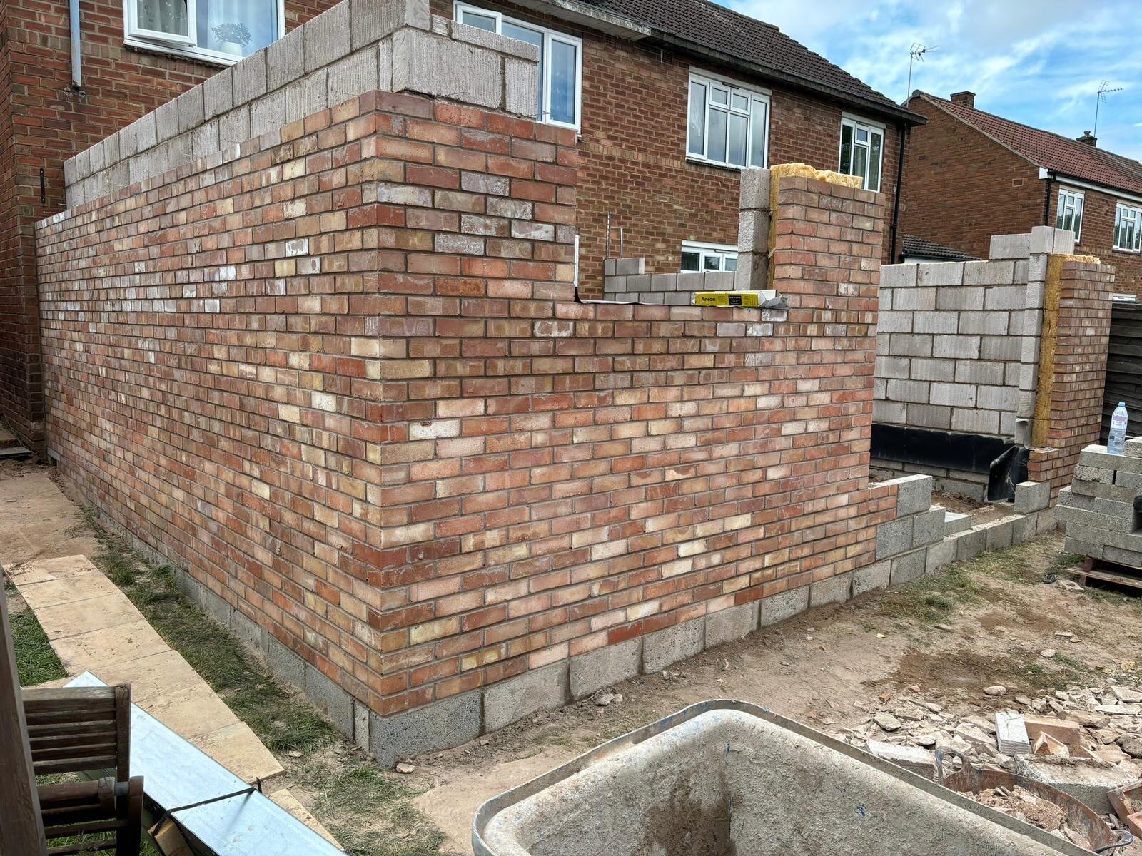 Extension cavity wall in reclaimed brickwork with wall ties and blockwork inner leaf
