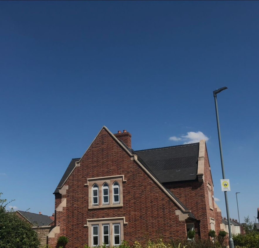 Completed traditional red brick new build home with feature gable and stone detailing
